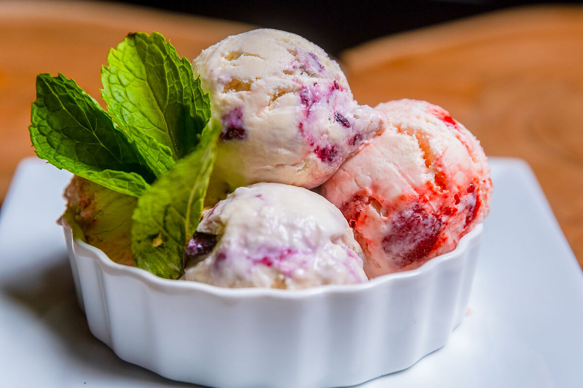Three scoops of house ice cream with fresh mint for a dessert menu